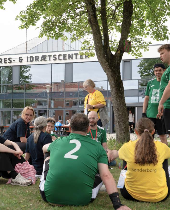 Deltagere og frivillige holder pause uden for Roskilde Kongres- og Idrætscenter