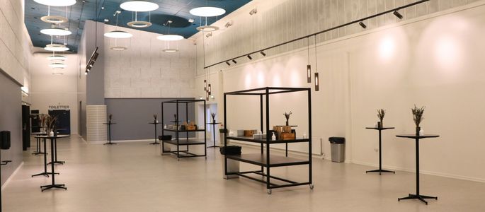 Vandrehallen i Roskilde Kongres- og Idrætscenter indrettet med højborde og mobile serveringsstationer til pauser, receptioner og ophold. 